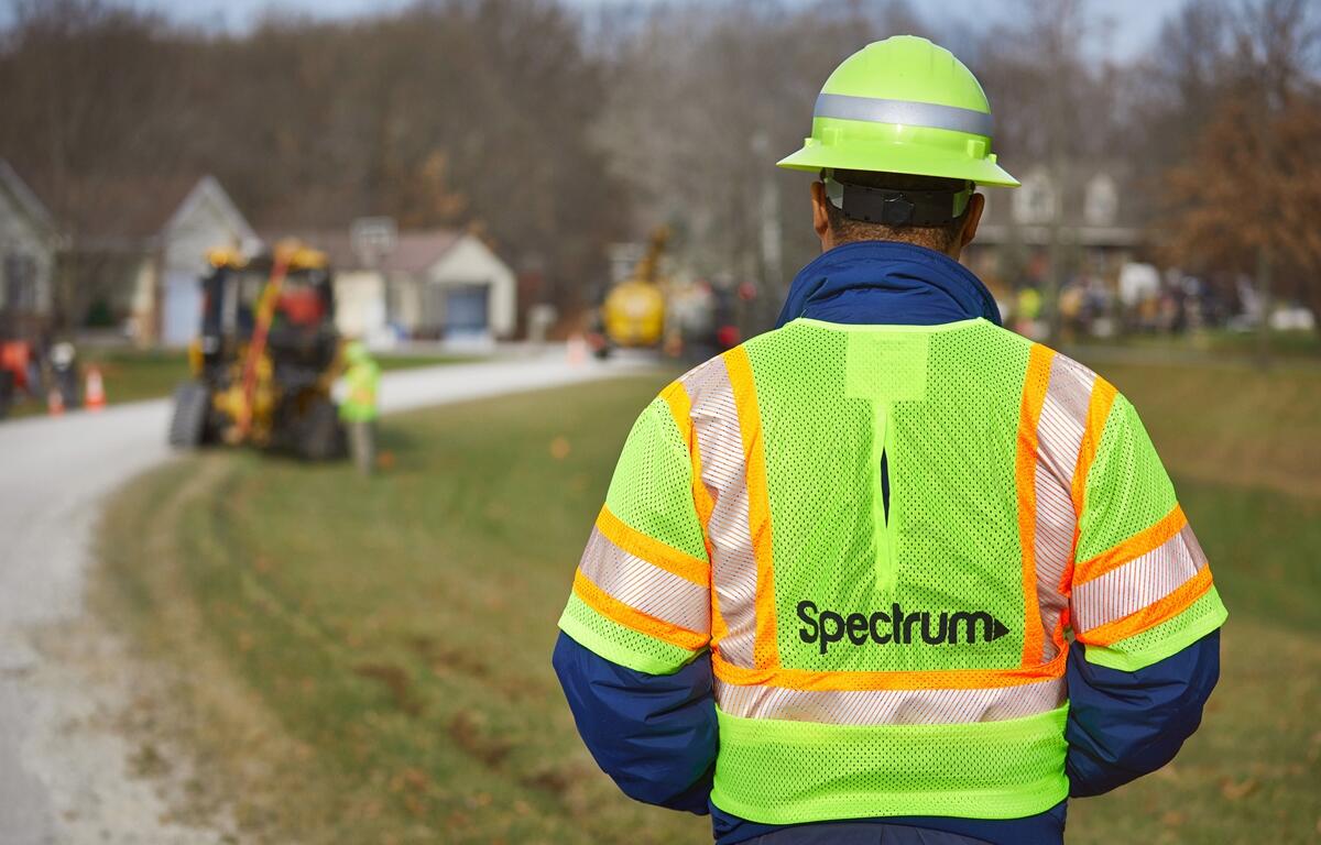 A Spectrum crew member monitors fiber-optic network construction in a residential neighborhood as part of the company’s rural broadband expansion in Marion County.