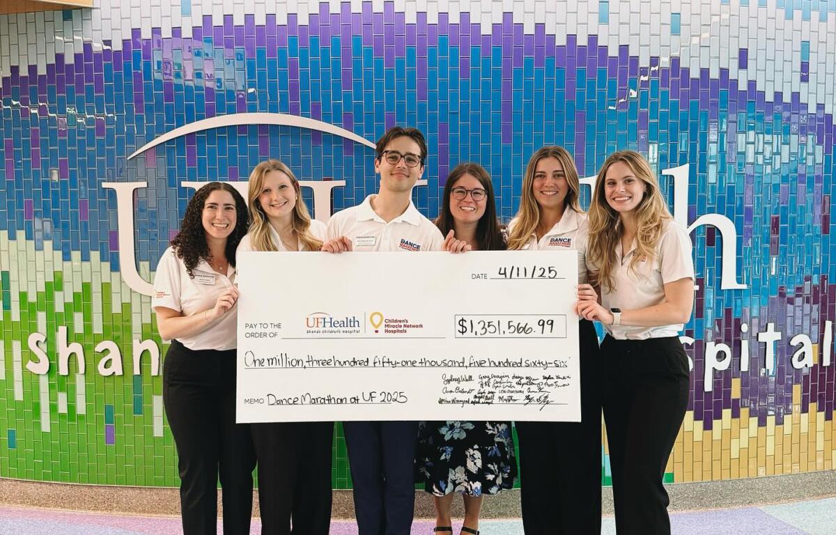 Members of UF's Dance Marathon present the check at UF Health Shands. 
