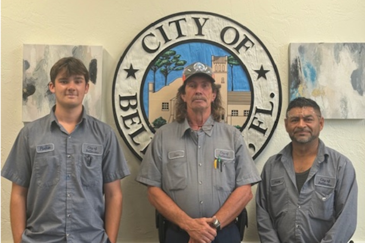 Three Belleview Public Works employees—Fisher Houston, Ronald Everett, and Henry Somarriba—stand in uniform in front of the City of Belleview seal after earning their CDL endorsements.