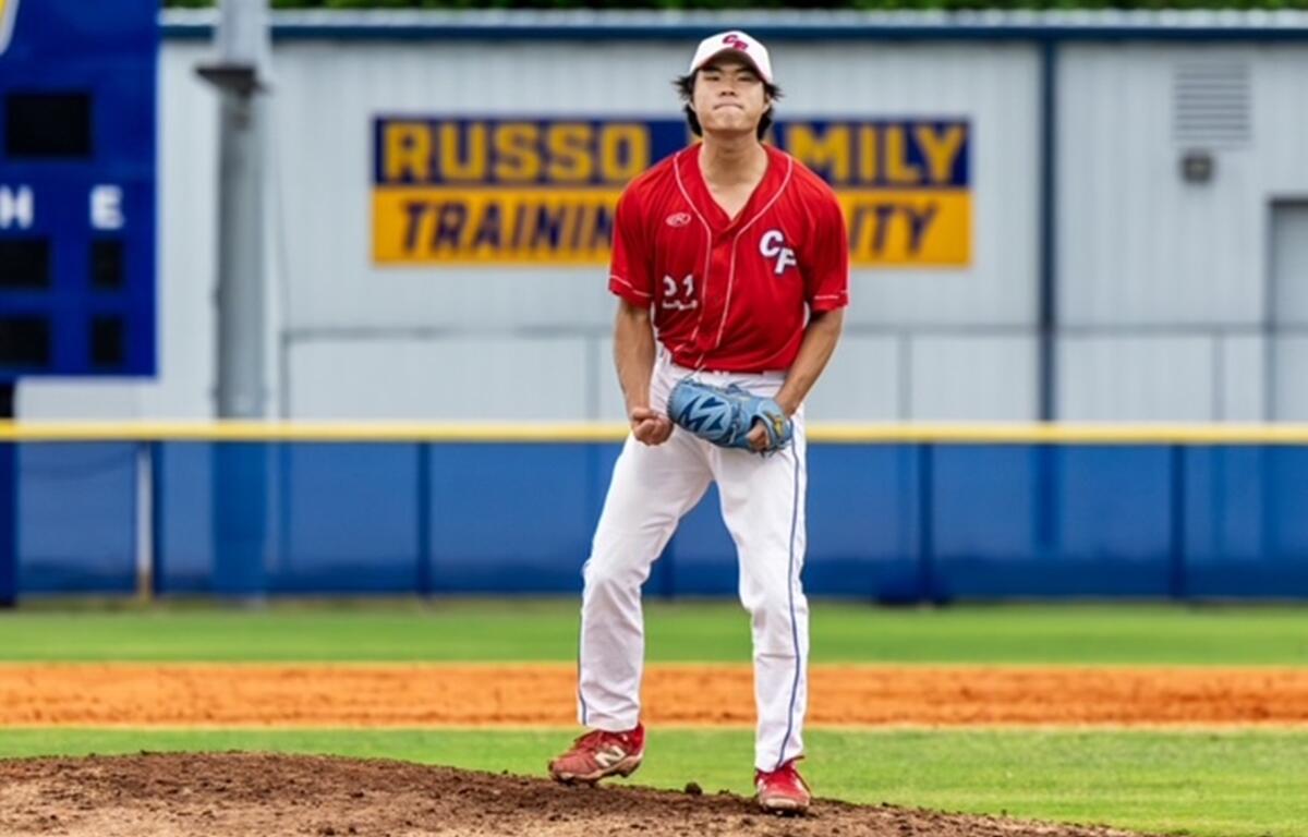 Jay Jung, wearing a red CF baseball jersey and white pants, clenches his fist and shows emotion on the pitcher’s mound after a key play during the FCSAA regional game at Indian River State College on May 2, 2025.
