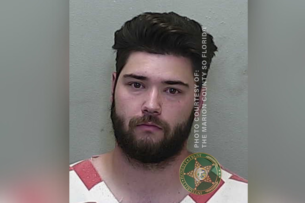 Mugshot of Gavin Kirby, a young man with dark hair and a beard, wearing a red and white jail uniform. The image includes the Marion County Sheriff's Office logo and a text watermark.