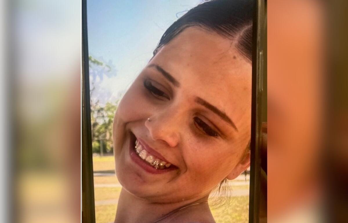 Close-up photo of Elizabeth Fulmer smiling outdoors, showing braces and wearing a nose stud.