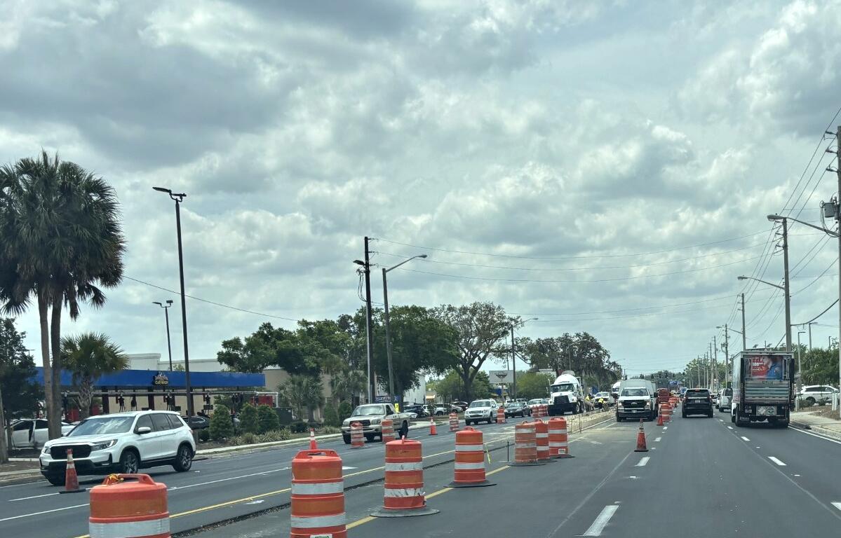 Traffic and construction barrels line State Road 200 in Ocala, Florida, during a roadway improvement project.