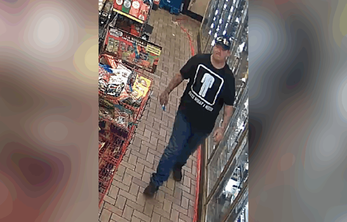 Accused thief wearing a black hat, black shirt, jeans and boots walks through Circle K store.