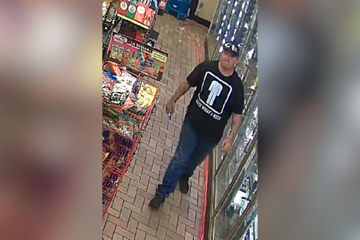 Accused thief wearing a black hat, black shirt, jeans and boots walks through Circle K store.