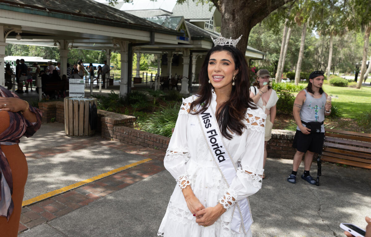 Miss Florida standing outdoors smiling and talking with visitors at Silver Springs.