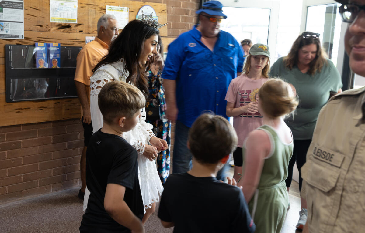 Miss Florida speaking with children and families inside the welcome center at Silver Springs.