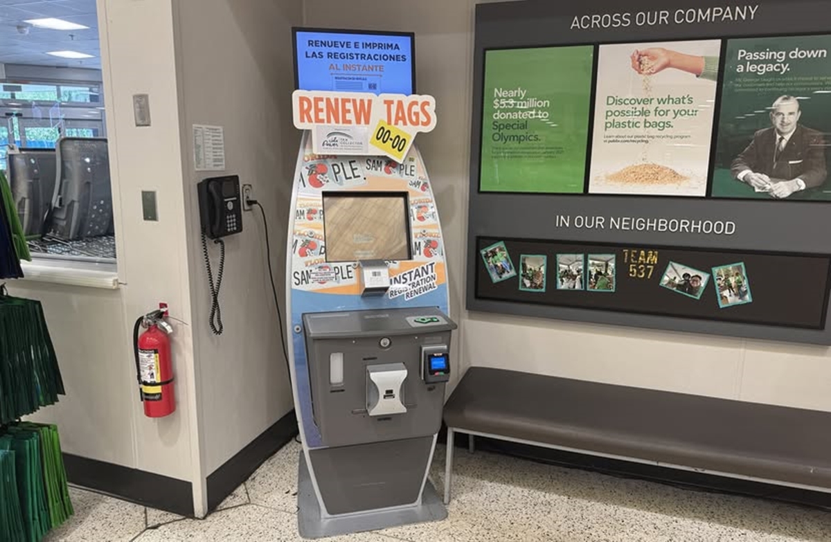 Self-service vehicle registration renewal kiosk inside a Publix store in Jonesville, Florida.