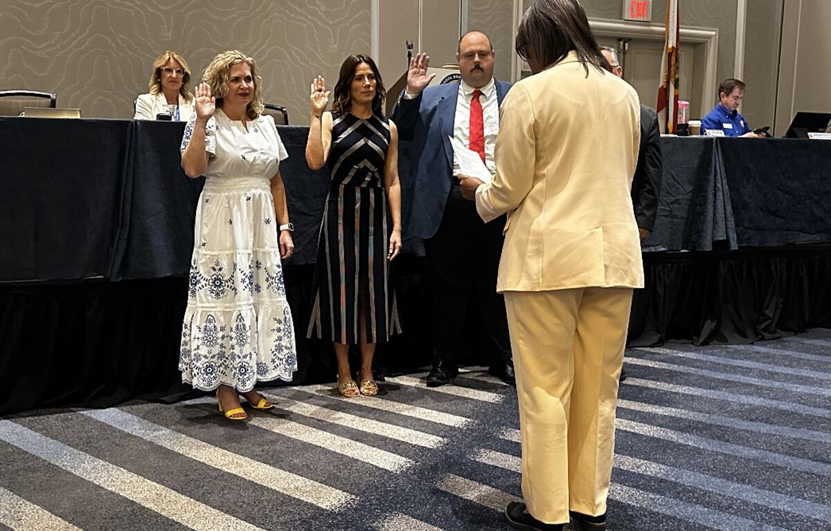 Dr. Allison Campbell raises her hand during a swearing-in ceremony as president-elect of the Florida School Boards Association in Tampa.