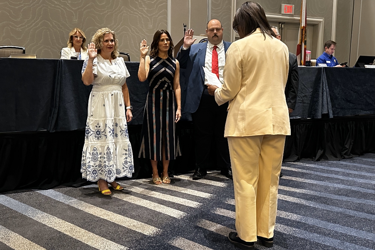 Dr. Allison Campbell raises her hand during a swearing-in ceremony as president-elect of the Florida School Boards Association in Tampa.