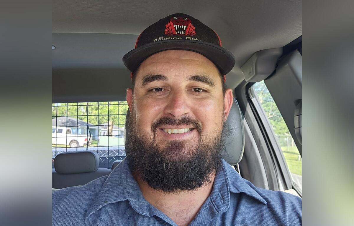 Clayton Caruthers smiling in a vehicle after being promoted to Field Operations Manager in Belleview.