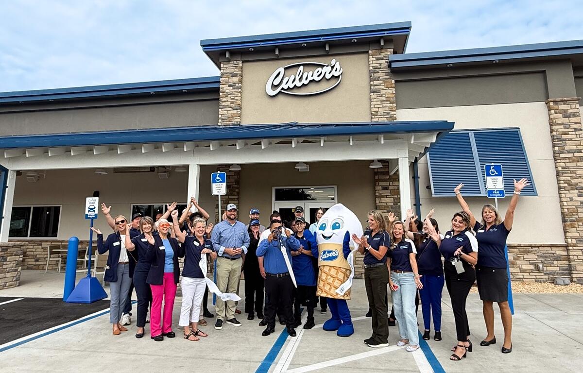 Large group of Culver’s staff and Ocala Metro CEP members cheer with mascot Scoopie in front of the new Ocala restaurant during the ribbon-cutting ceremony.