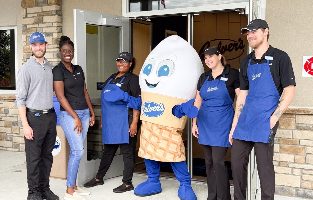 Culver’s employees smile and pose with mascot Scoopie at the entrance of the new Ocala restaurant.