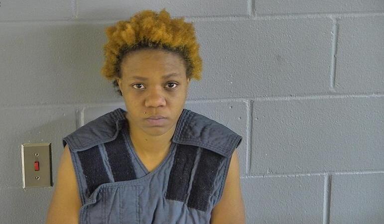 Person pictured is Chiane Carter, with orange-dyed hair and a blue shirt.