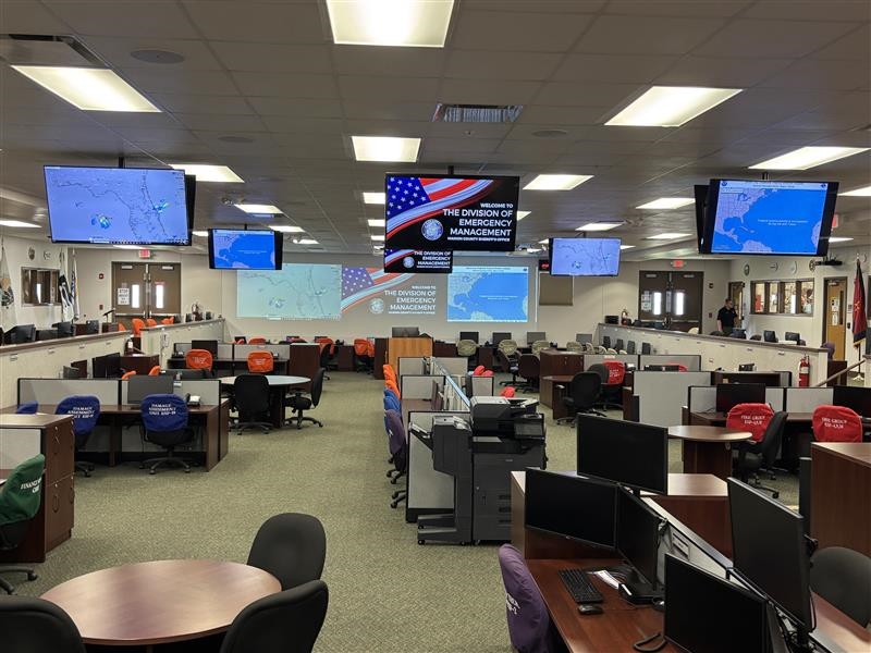 Interior view of the Marion County Emergency Operations Center with multiple workstations and large display monitors.