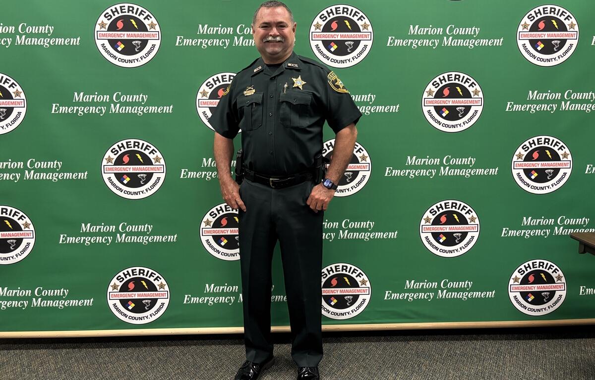 Preston Bowlin poses in uniform in front of a Marion County Emergency Management backdrop.