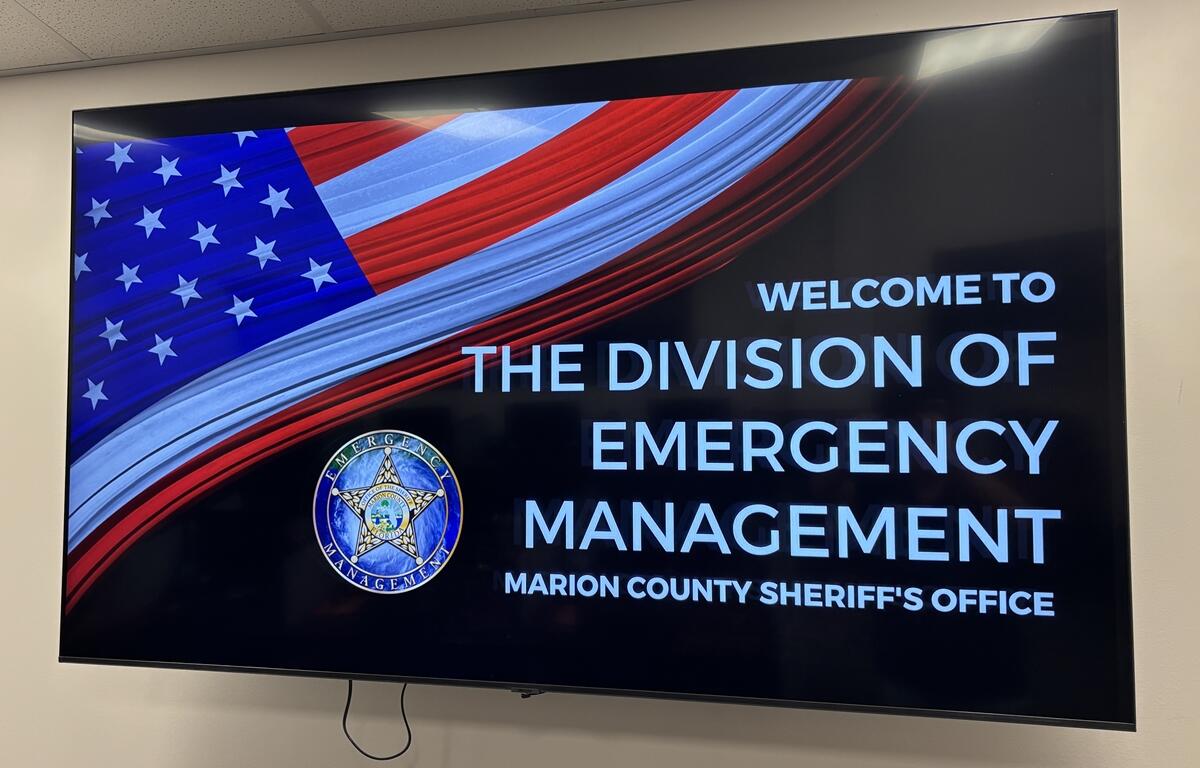 Digital display with American flag and Division of Emergency Management welcome message at Marion County EOC.