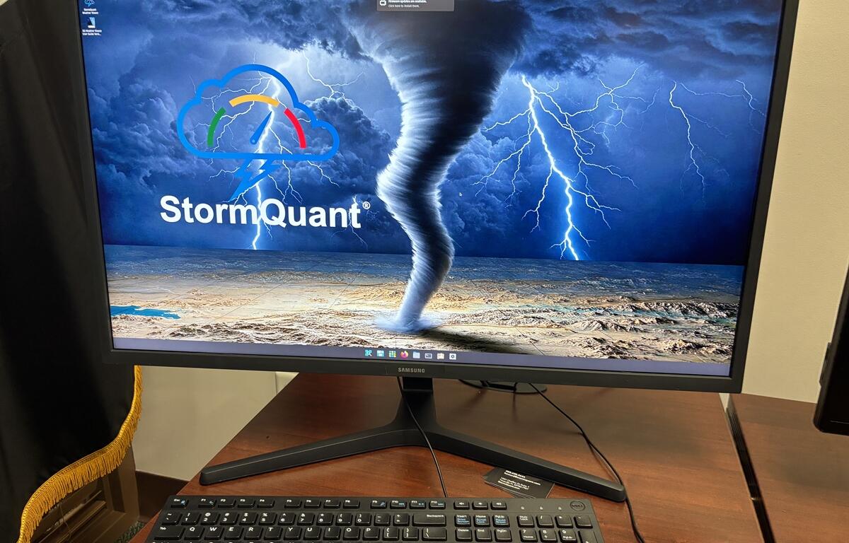Computer screen showing StormQuant software with a tornado and lightning graphic.