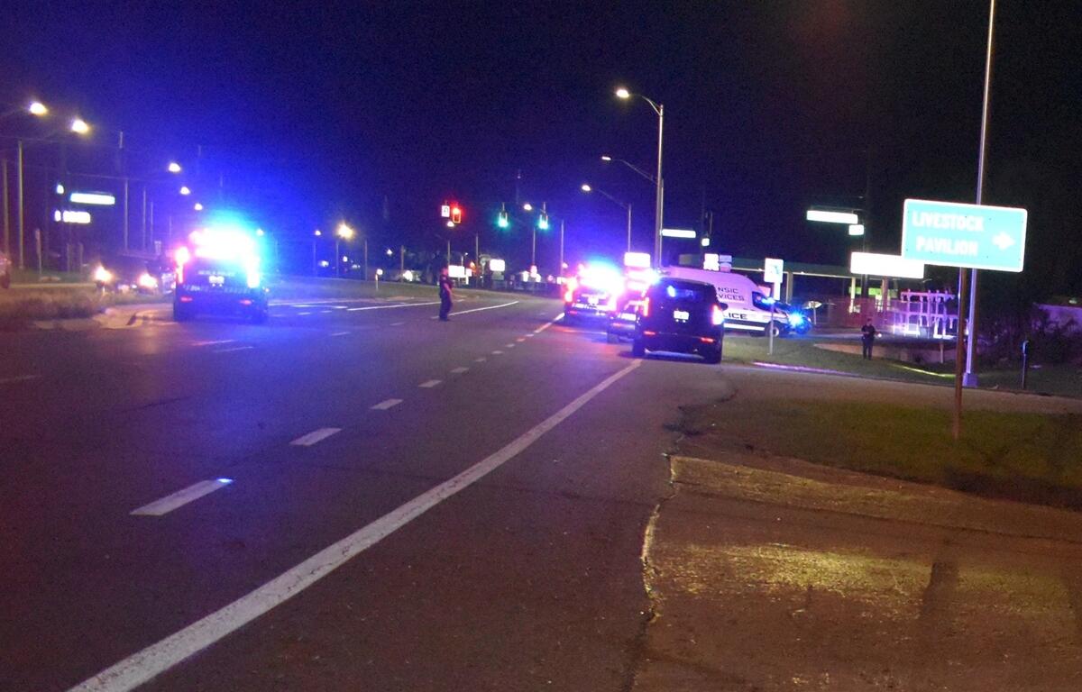 Police vehicles with flashing lights block lanes on North U.S. 441 at night following a fatal crash near the Livestock Pavilion in Ocala.