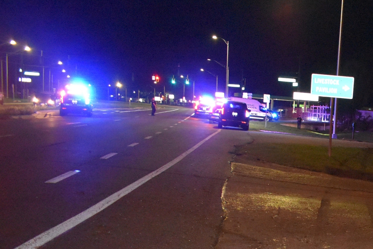 Police vehicles with flashing lights block lanes on North U.S. 441 at night following a fatal crash near the Livestock Pavilion in Ocala.