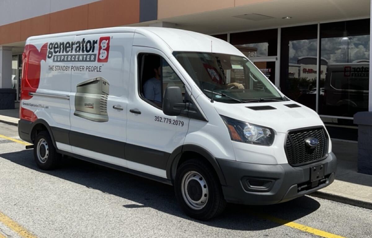 Generator Supercenter service van parked in front of Ocala showroom.