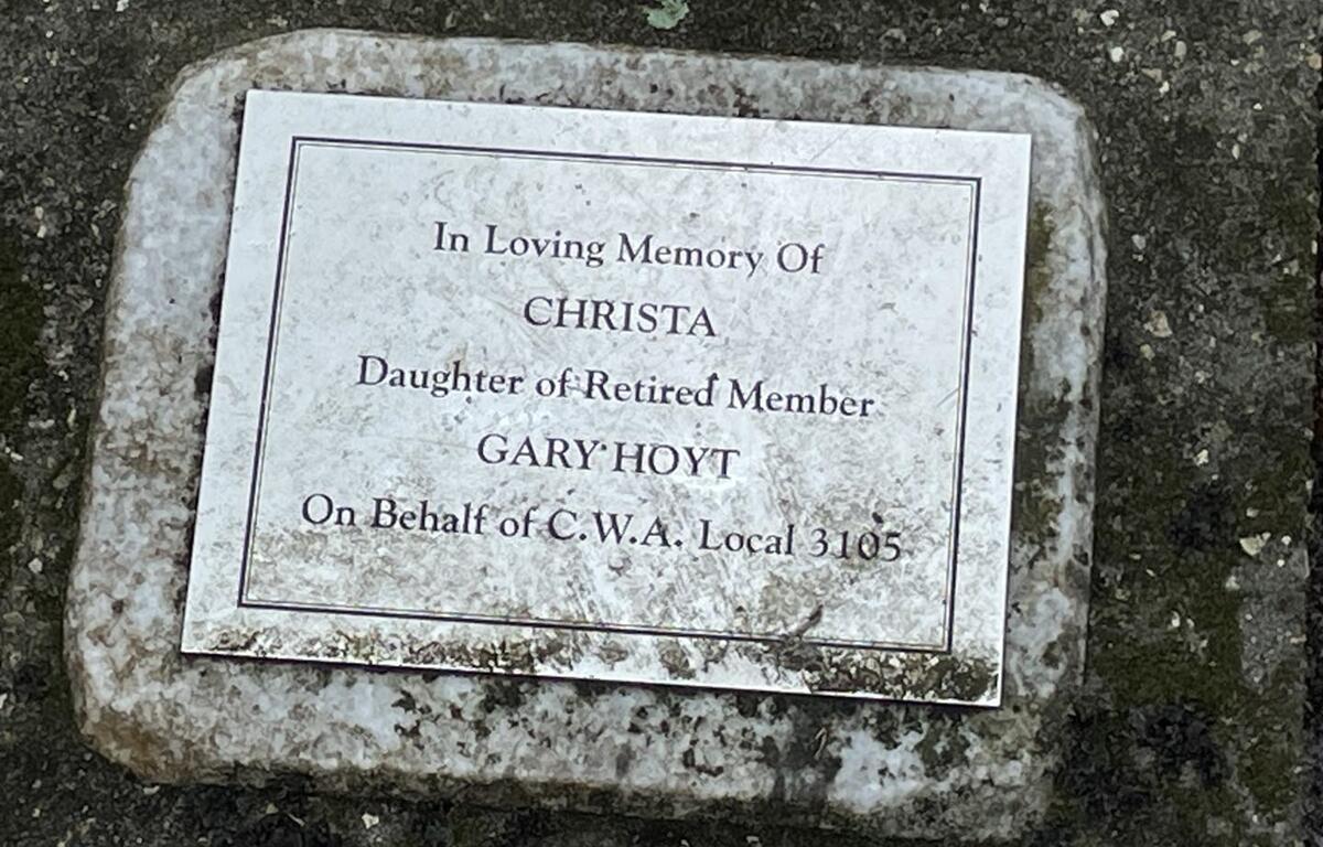 Stone memorial plaque in honor of Christa, daughter of retired union member Gary Hoyt, placed at Squirrel Ridge Park in Gainesville.