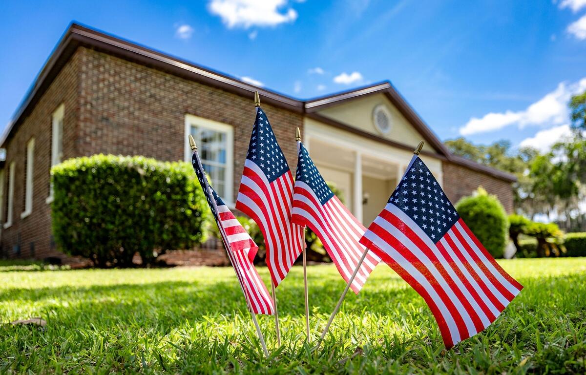 American flags on the lawn in front of the Heart of the Park building in Ocala, where HCA Florida Healthcare volunteers helped with cleanup and renovation.