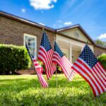 American flags on the lawn in front of the Heart of the Park building in Ocala, where HCA Florida Healthcare volunteers helped with cleanup and renovation.