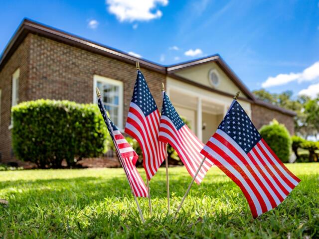 American flags on the lawn in front of the Heart of the Park building in Ocala, where HCA Florida Healthcare volunteers helped with cleanup and renovation.