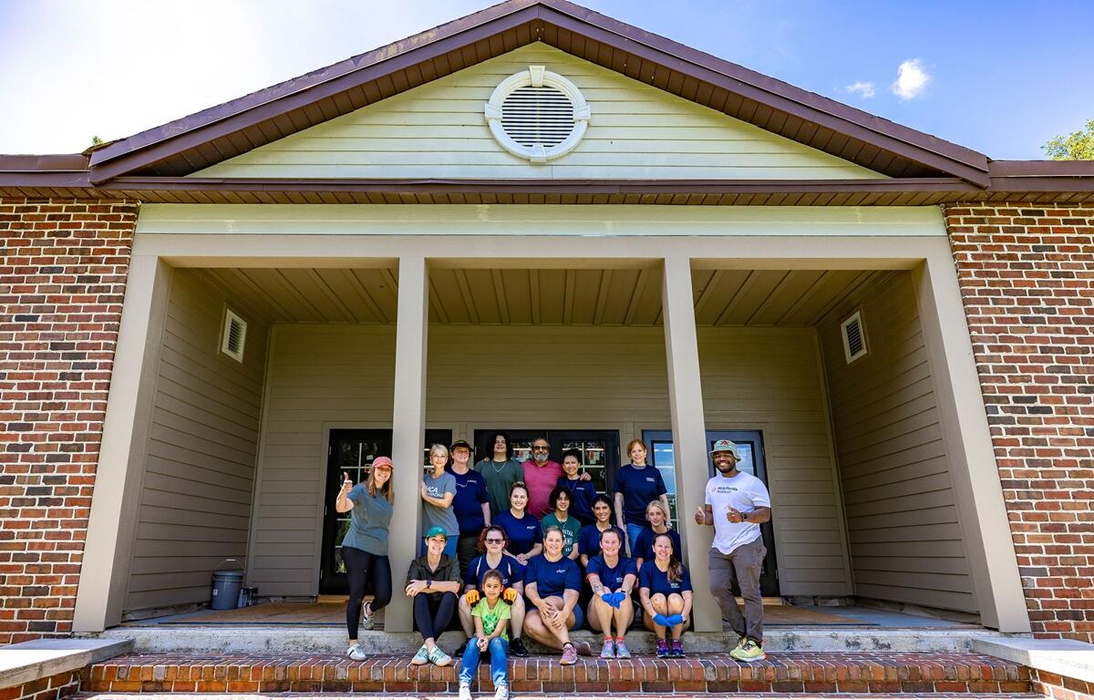 Group of HCA Florida Healthcare volunteers posing in front of the Heart of the Park building in Ocala.