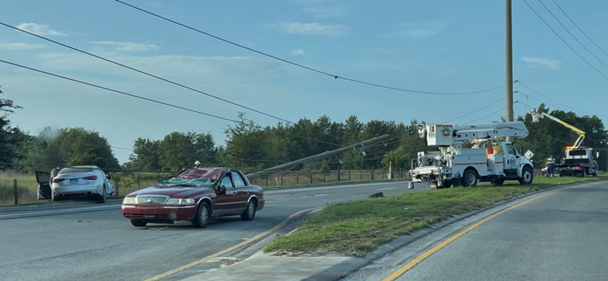 Utility crews respond to downed pole and damaged vehicles after a crash on SW 60th Avenue in Ocala.