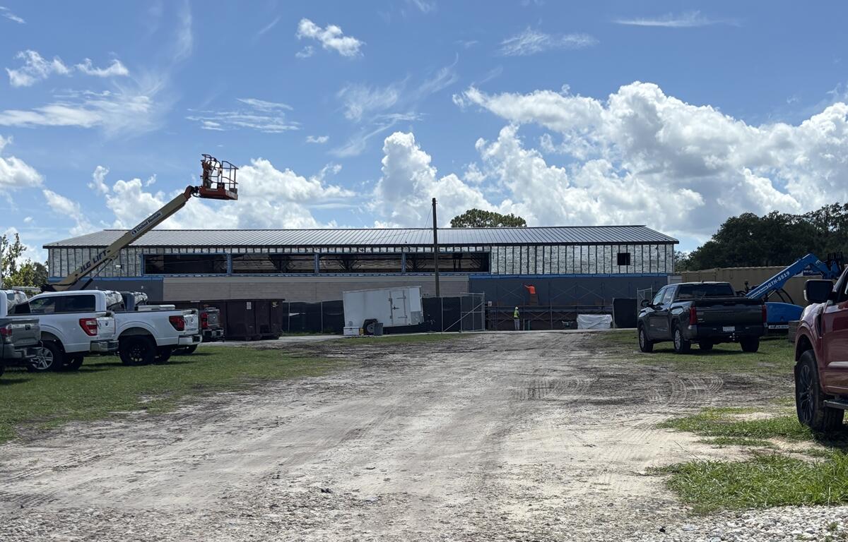 Construction equipment and workers at the site of a new gymnasium at Osceola Middle School in Ocala.