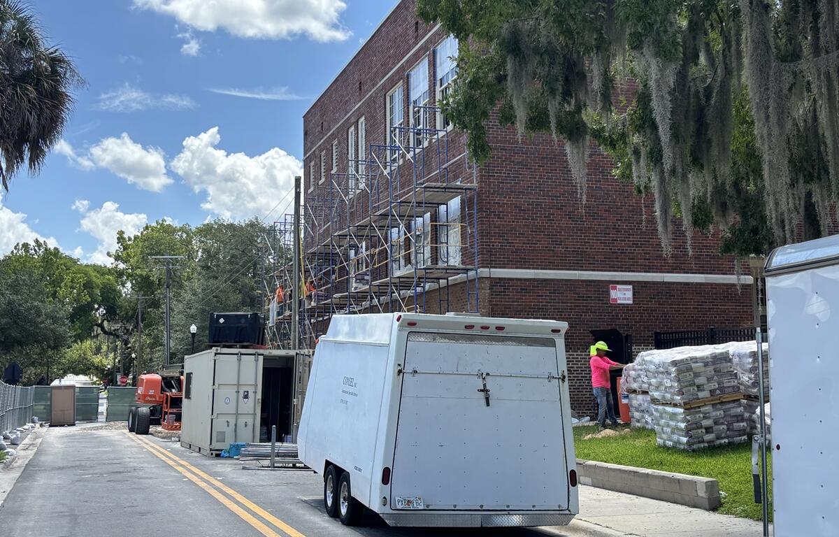 Scaffolding and workers on the brick exterior of Osceola Middle School’s historic Building 1 during renovation.