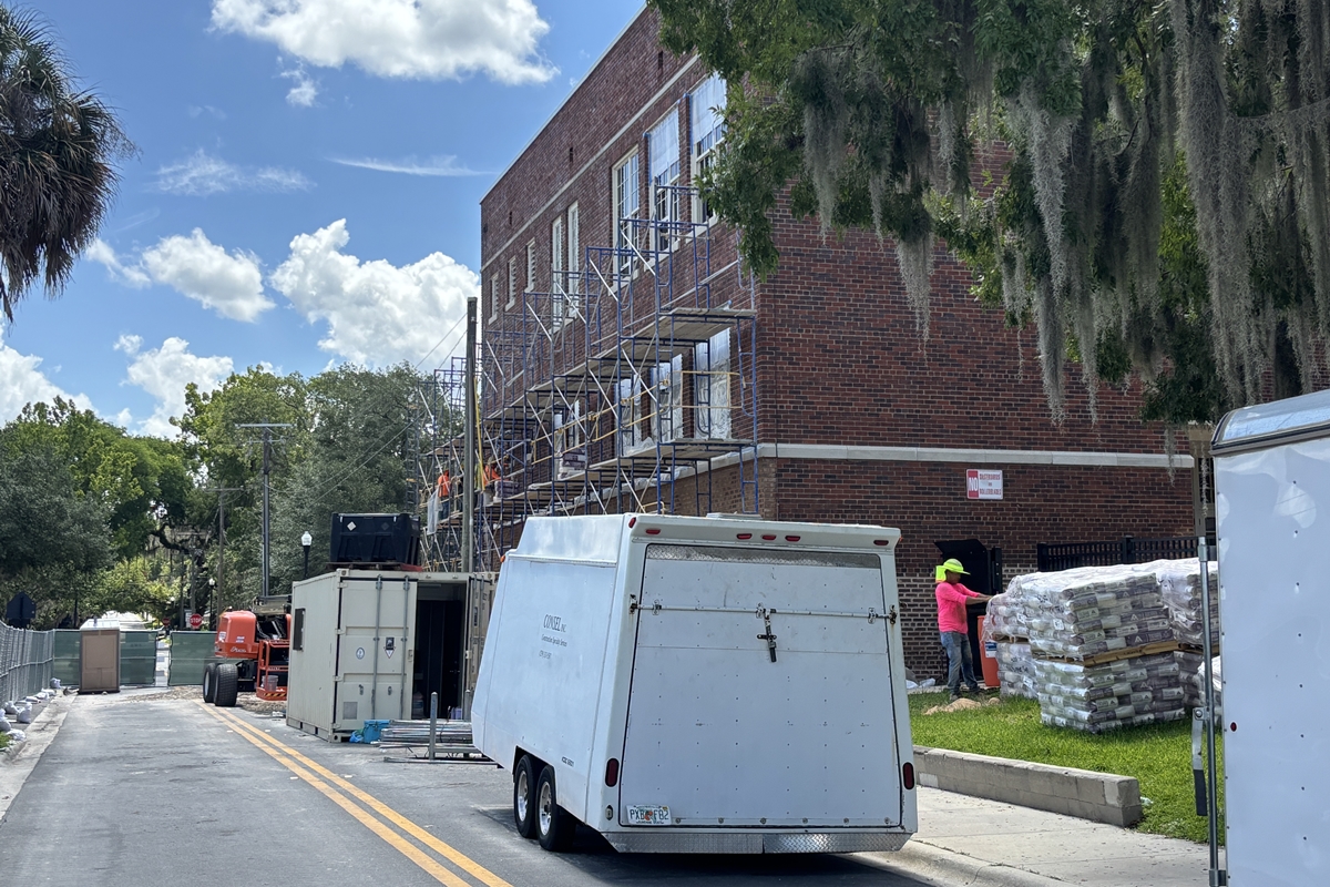 Scaffolding and workers on the brick exterior of Osceola Middle School’s historic Building 1 during renovation.