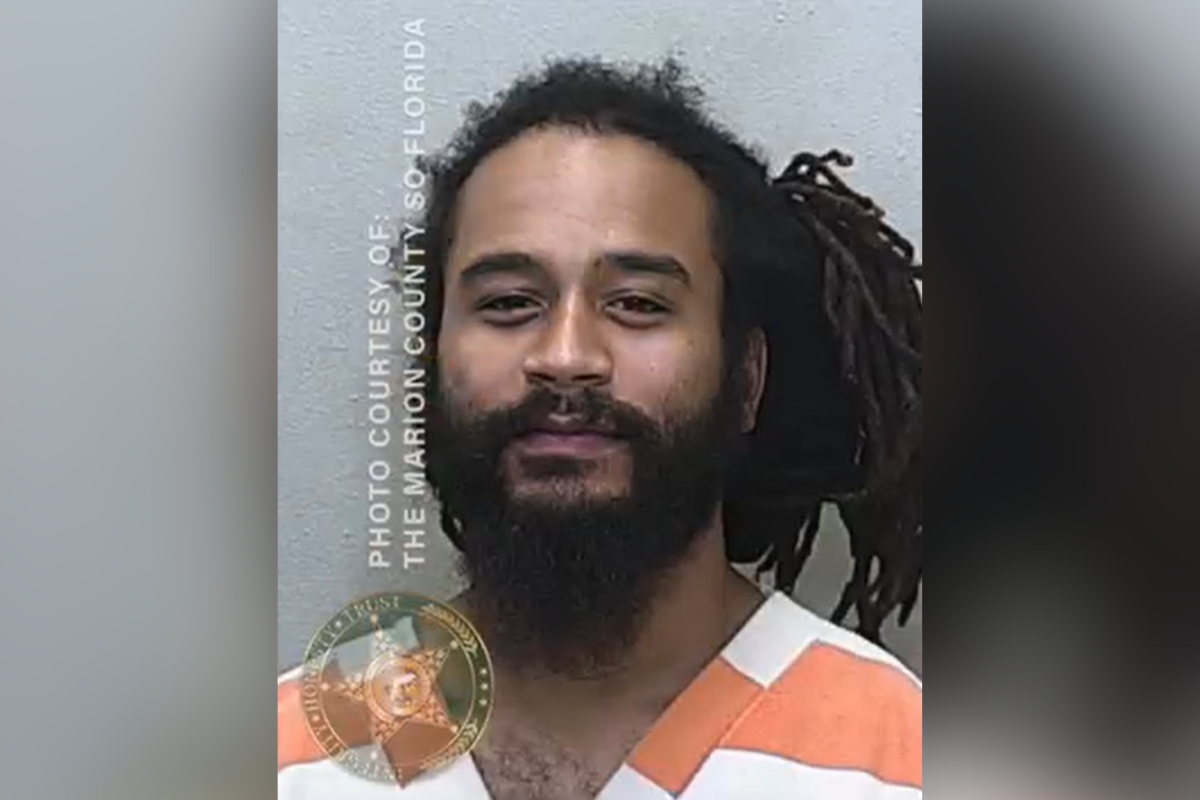 Mugshot of Joseph Andrade in orange and white jail uniform.