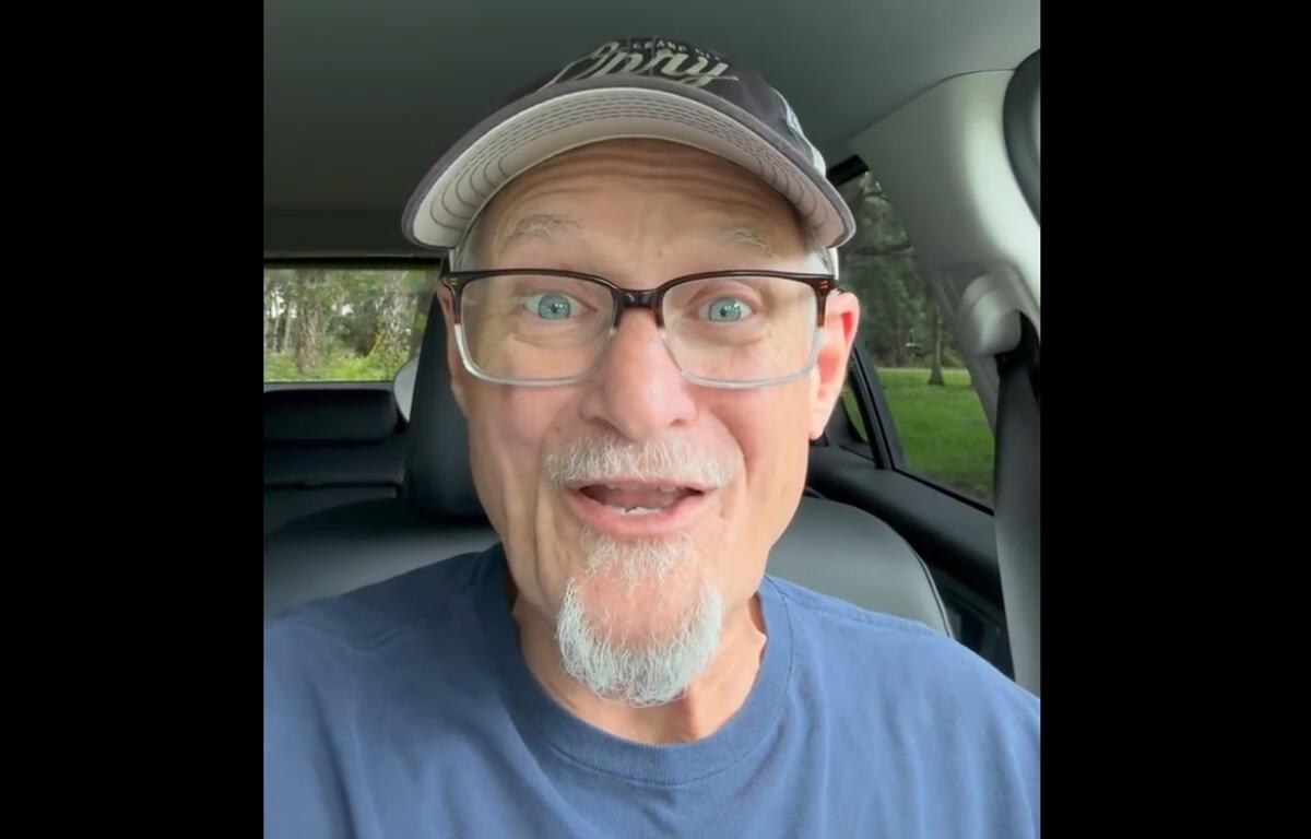 Comedian Killer Beaz smiles in a car during a promotional video