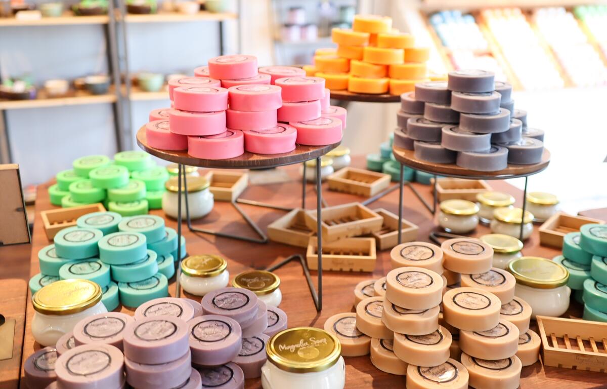 Colorful handmade soaps stacked on display tables inside Magnolia Soap and Bath Company in Ocala.