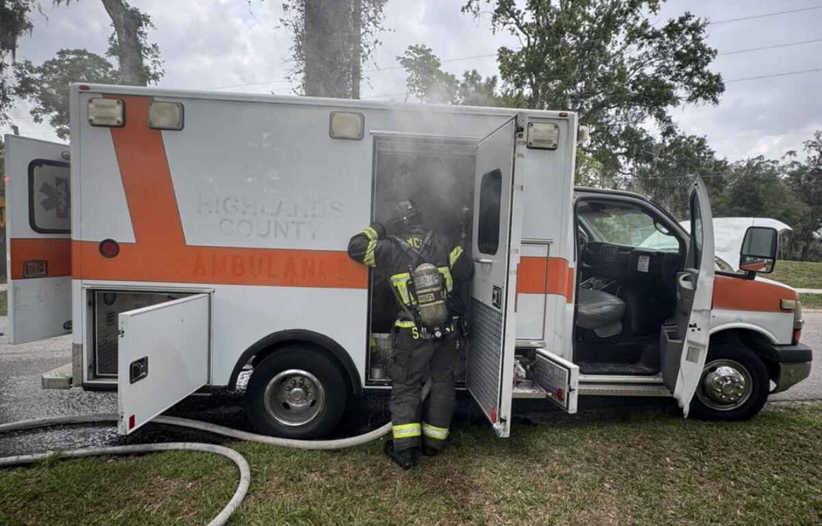 A firefighter dives into the smoke and blaze that filled the inside of an emergency vehicle.
