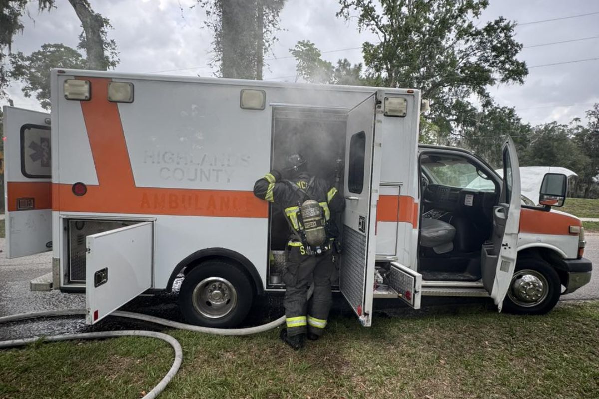 A firefighter dives into the smoke and blaze that filled the inside of an emergency vehicle.