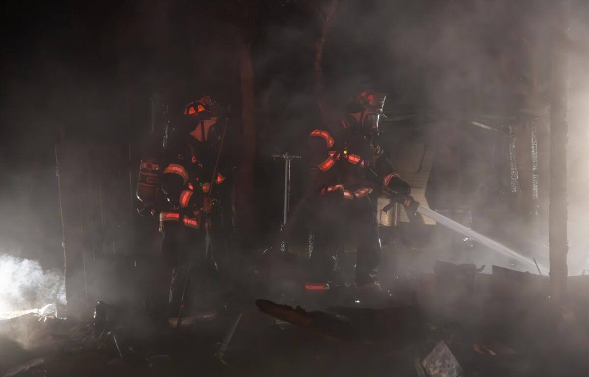 The fire appears to be completely out, and this is likely part of the investigation or recovery phase. Vegetation around the site shows minimal scorch marks, suggesting successful containment.