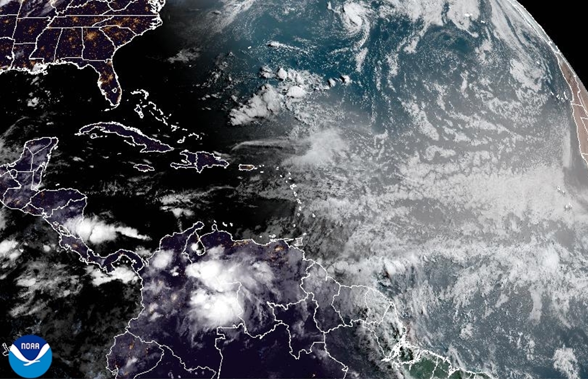 NOAA satellite view of cloud formations over the central Atlantic Ocean, with tropical activity visible near the Caribbean and off the coast of Africa.