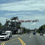 Crime Stoppers banner displayed over East Silver Springs Boulevard in Ocala, Florida, encouraging tips with cash rewards.
