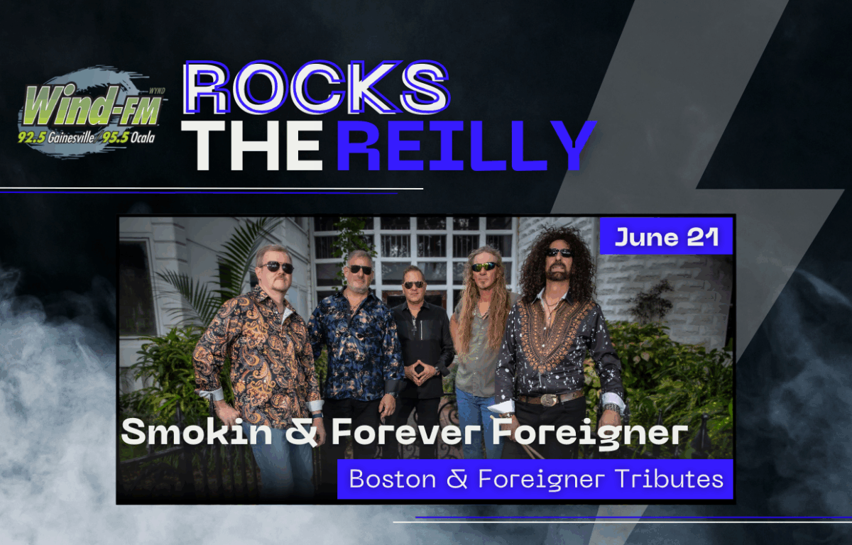 Promotional graphic for Wind-FM’s “Rocks the Reilly” event on June 21, featuring a photo of the tribute band Smokin’ & Forever Foreigner. The band members are standing outside in colorful patterned shirts and sunglasses. Text on the graphic highlights the concert's tribute to Boston and Foreigner at the Reilly Arts Center.