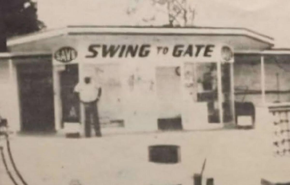 Rev. Leroy Johnson in front of his gas station labeled “Swing to Gate” in Ocala, Florida.