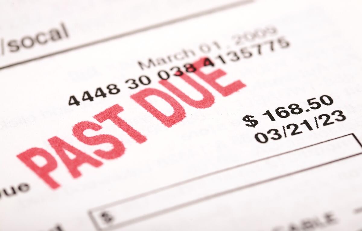 Close-up of a utility bill marked "PAST DUE" with an amount of $168.50 and due date of 03/21/23.