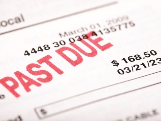 Close-up of a utility bill marked "PAST DUE" with an amount of $168.50 and due date of 03/21/23.