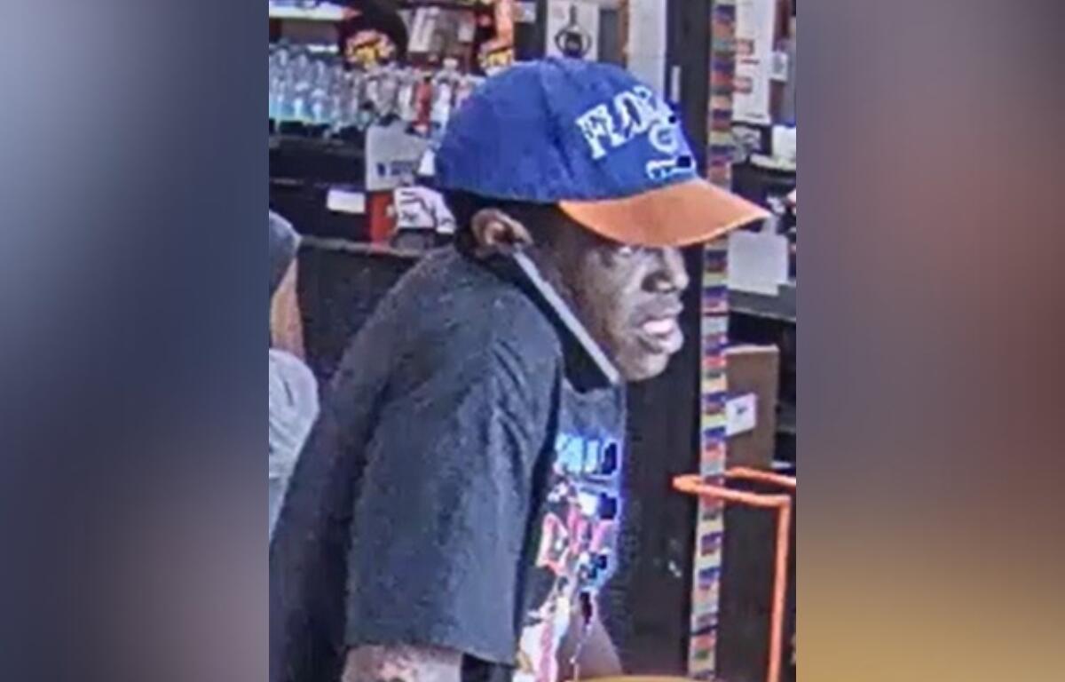 Surveillance image of theft suspect wearing a blue and orange Florida Gators cap inside Home Depot in Ocala.