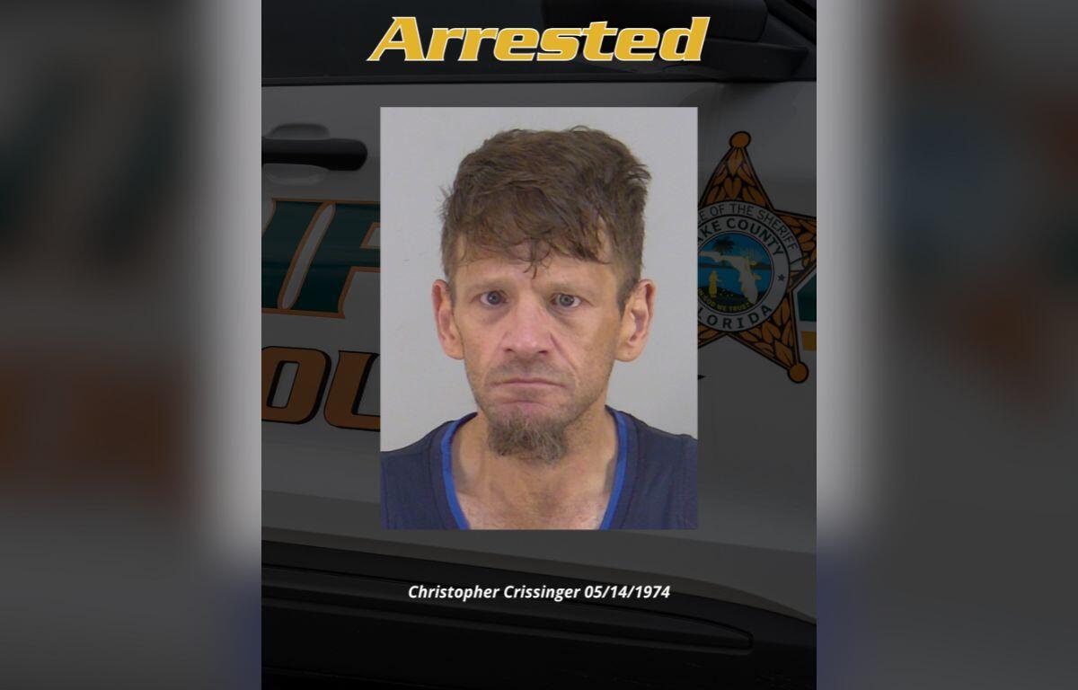 Image shows mugshot of man in center with text above which reads "Arrested" and the man's name and date of birth on a black background with a police car.