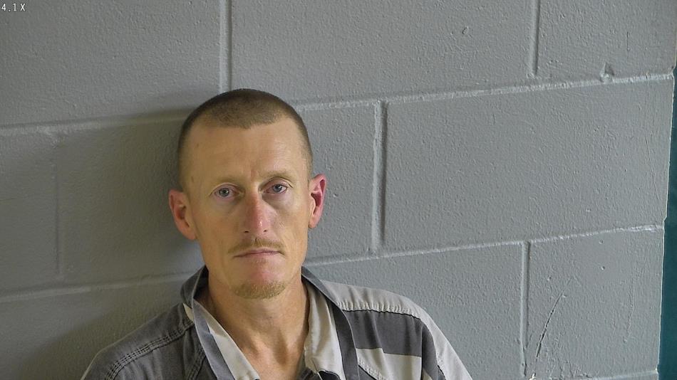 Pictured here is Clifton Spivey, with a bald head and a grey shirt.