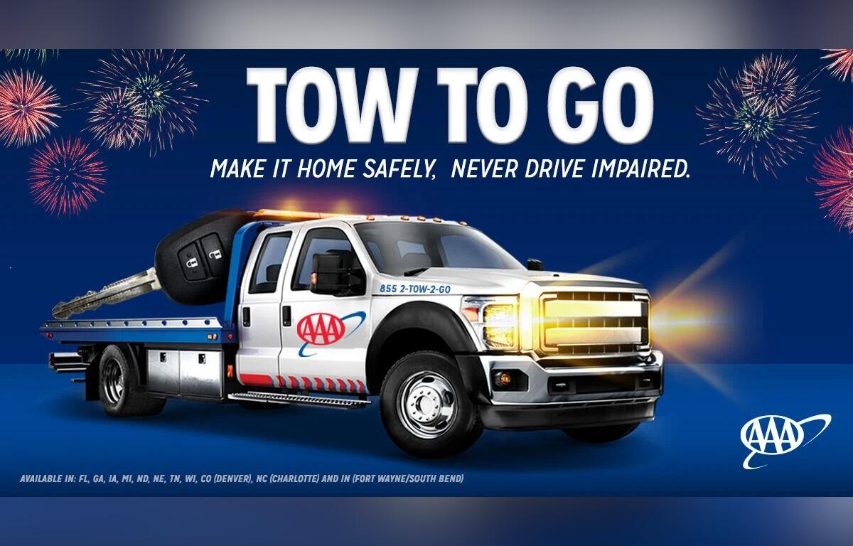 AAA Tow to Go promotional image with tow truck, large car key, fireworks, and service details.